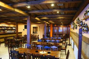an empty restaurant with wooden tables and chairs at Grillbar Penzion & Restaurant in Spišská Nová Ves