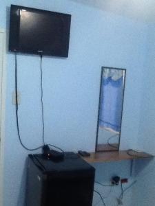 a television sitting on top of a table in a room at GELOXEL Angeles City Guesthouse in Angeles