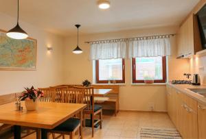 a kitchen and dining room with a table and chairs at Penzion U Bečvy in Karolinka +63 photos