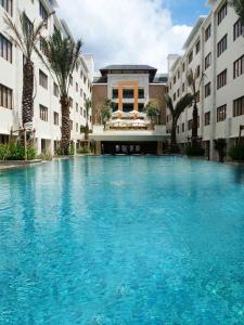 a large swimming pool in front of a building at Kuta Luxury Residence in Kuta