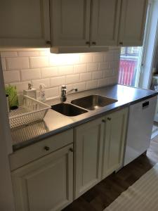 a kitchen with a sink and a counter top at Jaktlyckan, Tuna Gård in Tuna