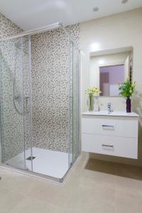 a bathroom with a shower with a sink and a mirror at Cabo Roig Terrazas de Campoamor 25 in Playas de Orihuela