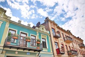 a building with balconies and potted plants on it at Downtown River Apartments in Tbilisi City