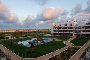 a view of a building with a pool and a building at Cabo Roig Terrazas de Campoamor 25 in Playas de Orihuela