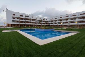 a large apartment building with a large swimming pool at Cabo Roig Terrazas de Campoamor 25 in Playas de Orihuela