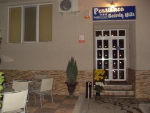 a restaurant with a table and chairs in front of a door at Pensiunea Beverly Hills in Baile Felix
