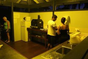 a man and a woman standing in a kitchen at Fraser Coast Top Tourist Park in Hervey Bay +34 photos