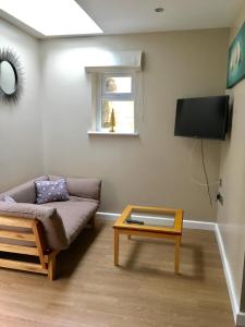 a living room with a couch and a table at Valley Mount House & Apartment in Harrogate