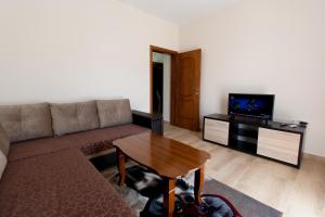 a living room with a couch and a table at Moonlight Apartments in Ulcinj