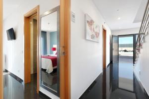 a hallway with a door leading to a bedroom at Sunfield Guest House - Only Adults in Albufeira