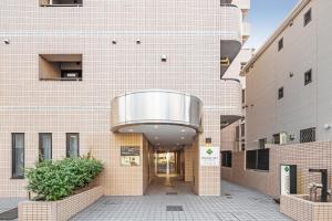 a building with a large metal dome on it at Flexstay Inn Sakuragicho in Yokohama