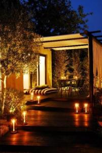 a patio with lights and a table in a house at Quinta da Lua in Tavira