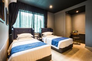 Postel nebo postele na pokoji v ubytování Manhattan Business Hotel TTDI