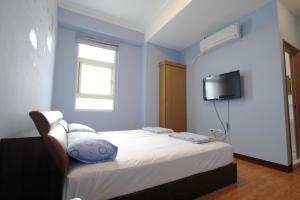 Llit o llits en una habitació de 驫風民宿 Equuleus Homestay