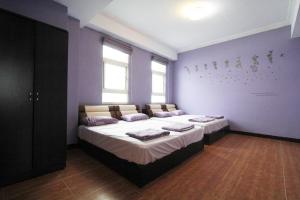 Llit o llits en una habitació de 驫風民宿 Equuleus Homestay