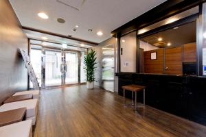 an office lobby with a table and chairs and a plant at FLEXSTAY INN Kawasaki Ogawacho in Kawasaki