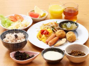 a table topped with different types of food at Hotel Roco Inn Okinawa in Naha