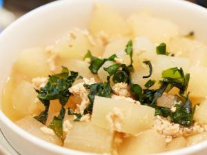 a bowl of soup with cheese and greens in it at Hotel Roco Inn Okinawa in Naha