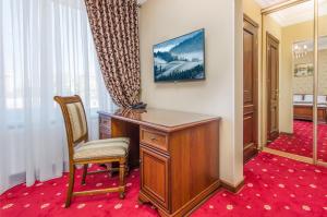 a room with a desk and a chair and a window at Park Lane Hotel in Chişinău