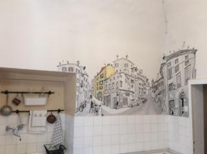 a bathroom with a mural of a city at Le Camere di Casa Cassandra in Perugia
