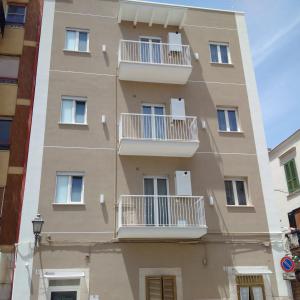 a building with white balconies on a street at Casa Vacanze De Nittis - Meridia Collection in Barletta