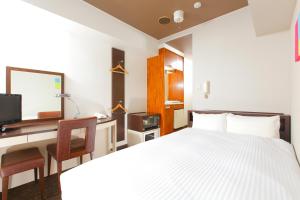 Postel nebo postele na pokoji v ubytování FLEXSTAY INN Kawasaki Kaizuka