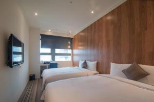 Rúm í herbergi á Merryday Hotel Banqiao
