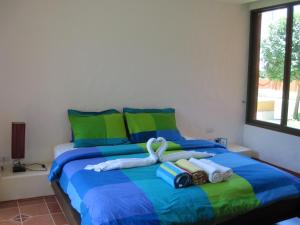 1 dormitorio con 1 cama con toallas en Las Tortugas Apartment Unit C101, en Khao Tao