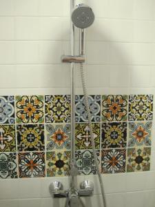 a shower in a bathroom with tiles on the wall at Las Tortugas Apartment Unit C101 in Khao Tao