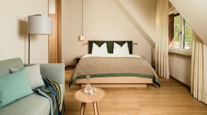 A bed or beds in a room at Ladurnerhof Boutique Apartments Meran