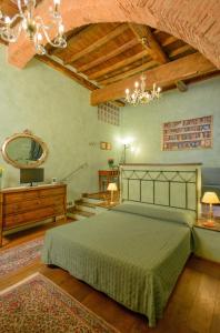 a bedroom with a bed and a mirror and a chandelier at B&B La Casa dei Tintori in Florence