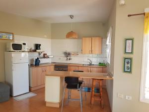 a kitchen with a counter and a sink and a refrigerator at Casa de Nico Naturaleza y atardeceres in Antigua