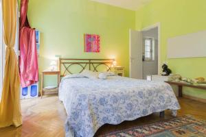 a bedroom with a bed with a blue and white blanket at La Camera Tra Gli Ulivi Dream Finale in Finale Ligure