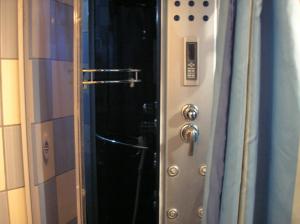 a door to a shower in a bathroom at Guesthouse Zeko in Aljmaš