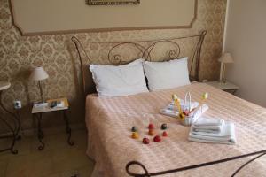 a bed with two towels and fruit on it at Royal Apartments in Niš