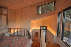 a room with a bed and two windows at Pipeline Chalet kunanyi Mt Wellington in Ferntree