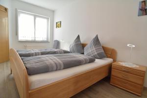 a bedroom with a wooden bed with a window at Ferienwohnung Weingarten in Klotten