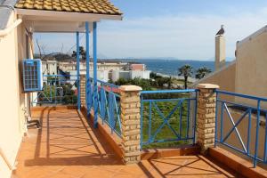 a balcony of a house with a blue railing at Apartment Elisabeth in Kanali