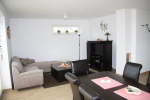a living room with a couch and a table at Ferienhaus Sophie in Thülsfeld