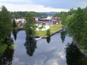 an aerial view of a river with houses and trees at Alcatraz in Gustavsfors