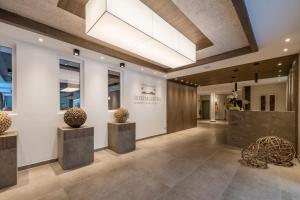 a lobby of a building with vases on display at Hotel Rosengarten in Nova Levante