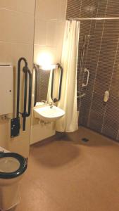 
a bathroom with a toilet, sink, and shower stall at The Briar Rose Wetherspoon in Birmingham
