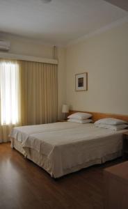 a bedroom with a large bed and a window at Miami Hotel in Mati