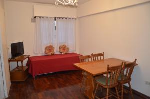 a room with a table and a table and a television at Apartamento Gutierrez in Mendoza