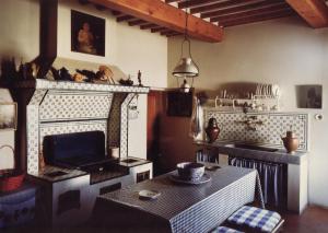a living room with a table and a fireplace at Villa Del Rimedio in Fucecchio