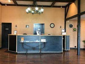 a counter in a room with a clock on the wall at Soudersburg Inn & Suites Lancaster in Ronks