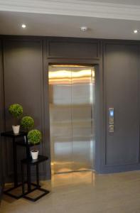 a elevator in a building with two potted plants at TheBlanc Boutique Hotel in Melaka