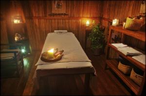 a room with a bed with a candle on it at Idylle Beach in Sainte Marie