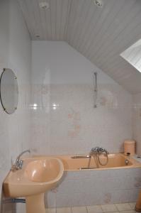 a bathroom with a sink and a bath tub at Perrault Gites in Loscouët-sur-Meu
