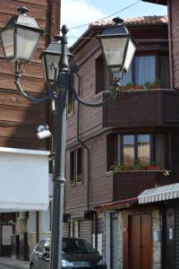 a street light with a car parked in front of a building at Guest Rooms Melsambria in Nesebar